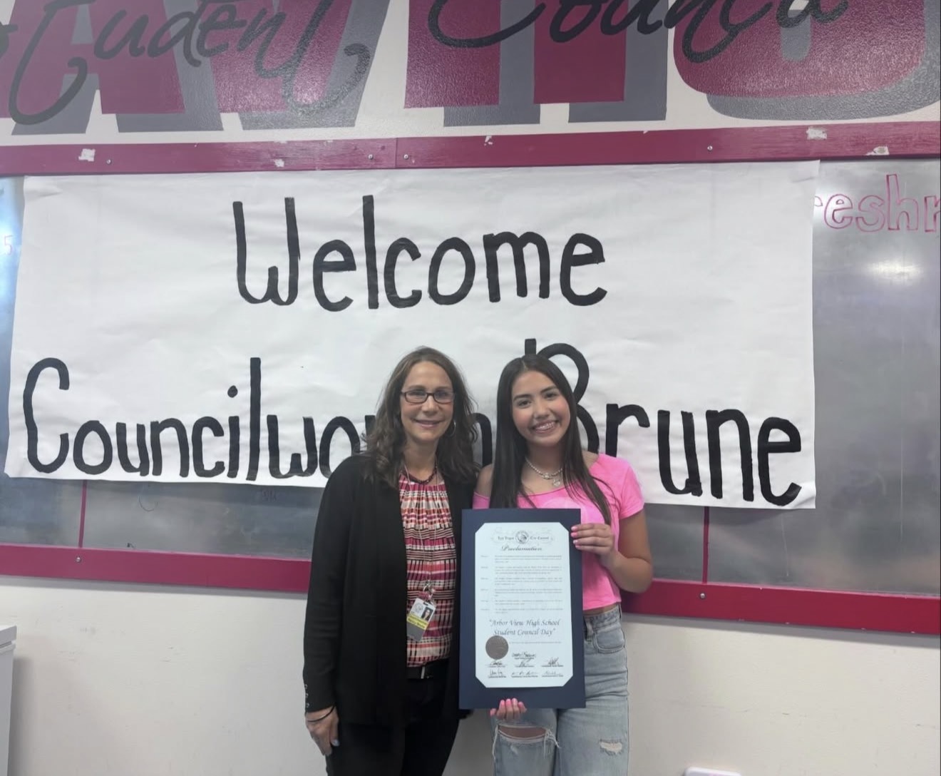 Aiyana Castro holding the Arbor View High School Student Council Day proclamation
