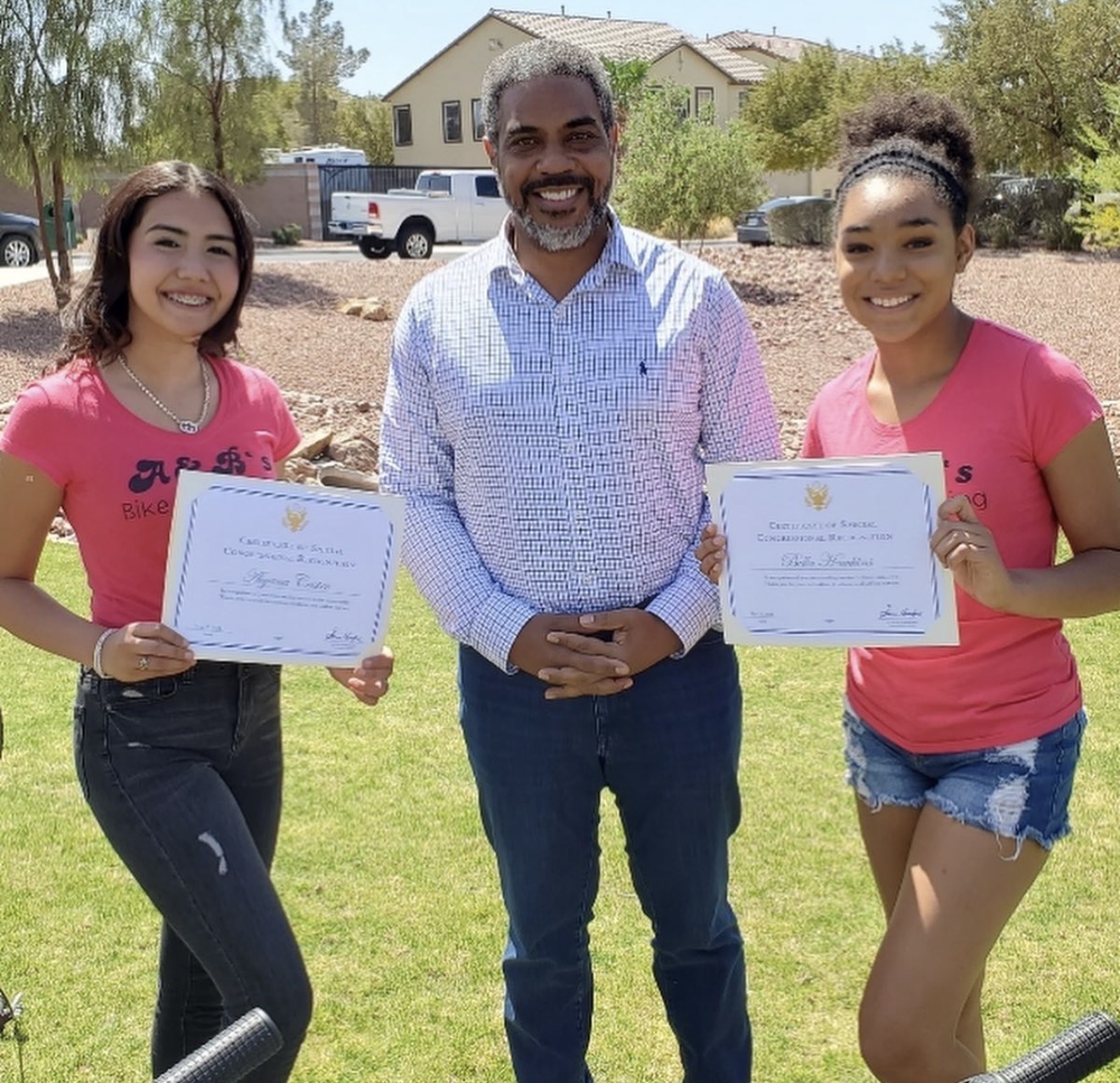 Aiyana Castro receiving a certificate of special congressional recognition from Representative Steven Horsford
